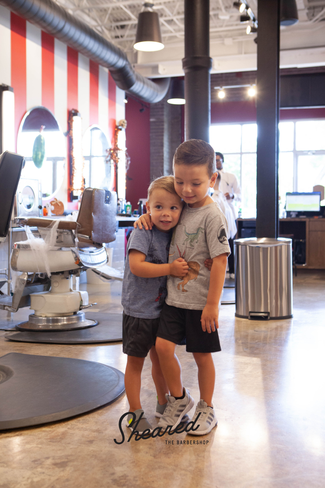 Barber at work inside Sheared The Barbershop